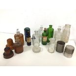 A collection of early 20thc glass bottles and jars, two with wooden outer casings, another with a