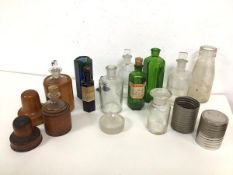 A collection of early 20thc glass bottles and jars, two with wooden outer casings, another with a