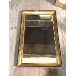 A modern rectangular wall mirror with concave gilt frame with ebonised edge (83cm x 53cm)