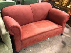 A 1930s/40s sofa, with hump back above scroll arms, on turned front supports terminating in