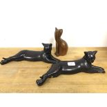 A pair of ceramic table sculptures in the form of Reclining Cats (each: 13cm x 38cm x 10cm) and a