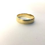 An 18ct gold wedding band, stamped 750 (U) (6.52g)