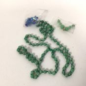 A string of polished stone beads, possibly jade (50cm) and a small quantity of assorted beads (a