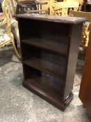 A 1930s/40s open bookshelf, the rectangular top with moulded edge above two shelves, on plinth