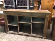 A large oak sideboard, the rectangular top above three frieze drawers and three adjustable