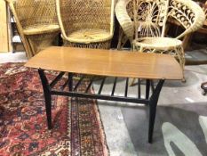 A 1960s/70s coffee table with rectangular teak top, with rounded corners, on ebonised supports