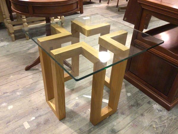 A contemporary occasional table with square glass top on geometric oak base (50cm x 60cm x 60cm)