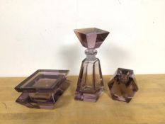 An amethyst coloured glass dressing table set, includes a scent bottle (20cm), candleholder and