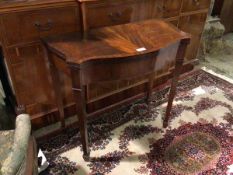 A reproduction Georgian style card table, the serpentine front opening and twists to a green baize