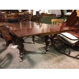 A Victorian extending mahogany dining table, the rectangular top with two draw leaves on turned