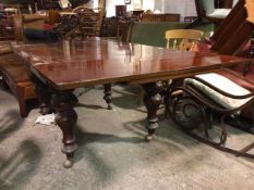 A Victorian extending mahogany dining table, the rectangular top with two draw leaves on turned