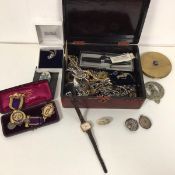 A collection of costume jewellery including imitation pearl necklaces, badges, brooches, medals,