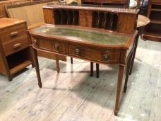 An Edwardian mahogany desk, the superstructure with an arrangement of pigeonholes and cupboards,