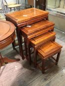 A set of four Chinese nesting tables, the rectangular tops above moulded frieze, on straight