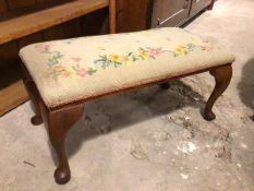 A 1930s/40s footstool, the grospoint top of floral design, on cabriole supports ending in pad