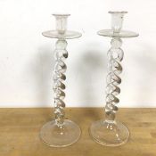 A pair of glass candlesticks, the candleholder over a drip tray on barley twist stem, with