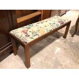 A 1940s footstool, the grospoint drop in top with floral pattern, above a moulded apron, on straight