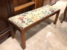 A 1940s footstool, the grospoint drop in top with floral pattern, above a moulded apron, on straight