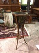 An Edwardian mahogany plant stand, the cage top with circular metal insert, on tripod support united
