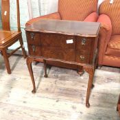 A reproduction lowboy, with serpentine front, fitted two frieze drawers, on cabriole supports with