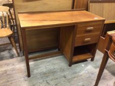 A mid century teak desk, the rectangular top with ledgeback, fitted two drawers to right above