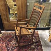A modern elm rocking chair with comb back, the seat stamped with a chair with initials CC, on