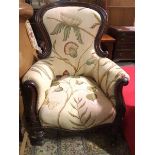 A Victorian spoon back armchair, the scroll arms with acanthus carving, in a floral linen
