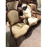 Two his and hers 19thc French walnut armchairs, each with a foliate carved top rail, above padded