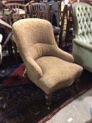 A Victorian nursing chair with foliate pattern upholstery, with serpentine front, on turned front