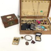An assortment of costume jewellery including earrings, white metal bangle, badges, necklaces etc.,