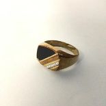 A 9ct gold gentleman's signet style ring with triangular shaped inset onyx panel on band with