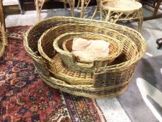 A graduated set of four wicker vintage dog baskets (largest: 35cm x 97cm x 78cm)
