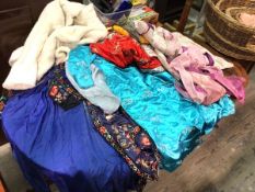 A quantity of clothing and textiles including several kimonos, a lace blouse, blue dress, jackets