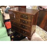 A reproduction mahogany Georgian style chest of drawers, with moulded top above two short drawers