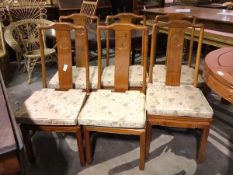A set of six Chinese yoke back chairs, with carved medallions to splat, each with squab seat