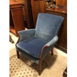 A Parker Knoll low armchair with scroll arms and blue upholstered back, arms and seat cushion, on