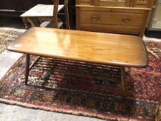 An Ercol elm surf board style coffee table, on turned supports united by spindle undertier (36cm x