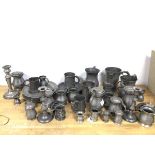 A quantity of pewter including candlesticks, tankards, measures, jugs (candlestick: 21cm), some with