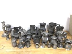 A quantity of pewter including candlesticks, tankards, measures, jugs (candlestick: 21cm), some with