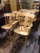 A set of six beech dining chairs, two carvers, four side chairs, the curved backs above pierced