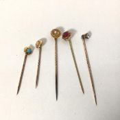 A group of five stick pins, early 20thc., one set with seed pearl, pin stamped 10, the second with a