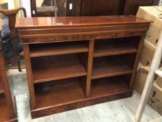 A Georgian style reproduction open bookcase, with rectangular top above reeded frieze, adjustable