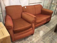 A 1920s two piece lounge suite comprising an upholstered easy chair and two seater drop end sofa, in