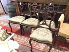 A set of four 18thc inspired side chairs, with intricately carved top rails and splats,