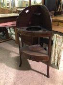 An Edwardian mahogany corner washstand with rounded ledge back above a lower tier with single