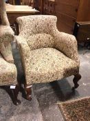 An early 20thc library chair, with later foliate upholstery, on cabriole supports with castors (72cm