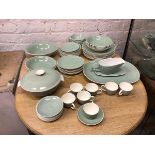 A part Poole dinner service in celadon green including eight dinner plates (26cm), seven demi