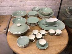 A part Poole dinner service in celadon green including eight dinner plates (26cm), seven demi