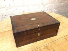 A 19thc rosewood box with mother of pearl inlay, the hinged lid opening to a papered interior with