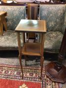 An Edwardian mahogany plant stand, the inlaid square top above a lower tier on turned supports (83cm